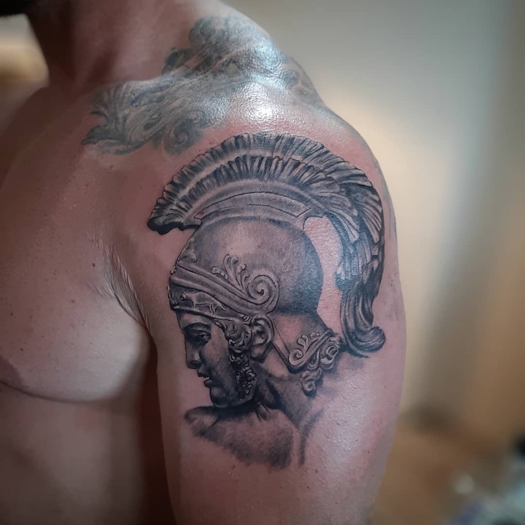 Tattoo of Achilles with a helmet on an upper arm and shoulder