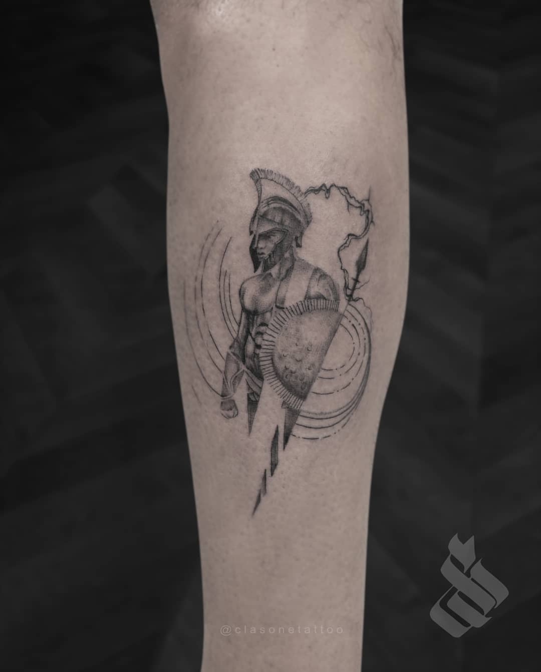 Tattoo of Brad Pitt playing Achilles with a circular design on the back of a calf