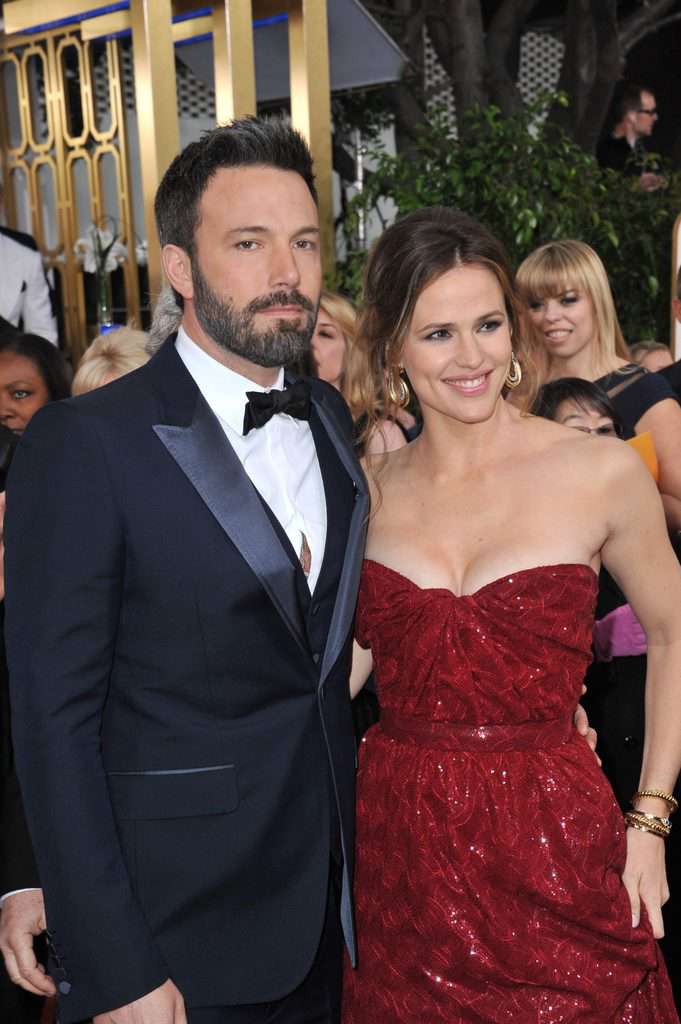 A picture of Ben Affleck in his black suit tie with Jennifer Garner in her red strapless dress
