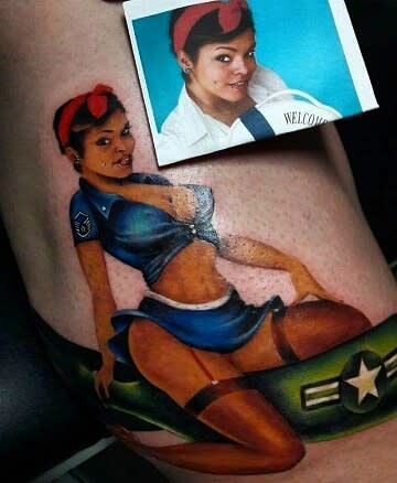 Tattoo of a pin-up girl in a military-style outfit 