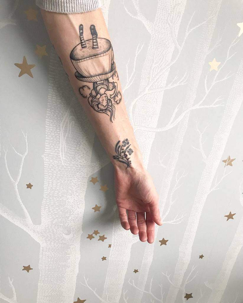 Black and white tattoo of Alice from Alice in Wonderland, falling upside down with her legs in the air, surrounded by whimsical details like swirling lines and clouds