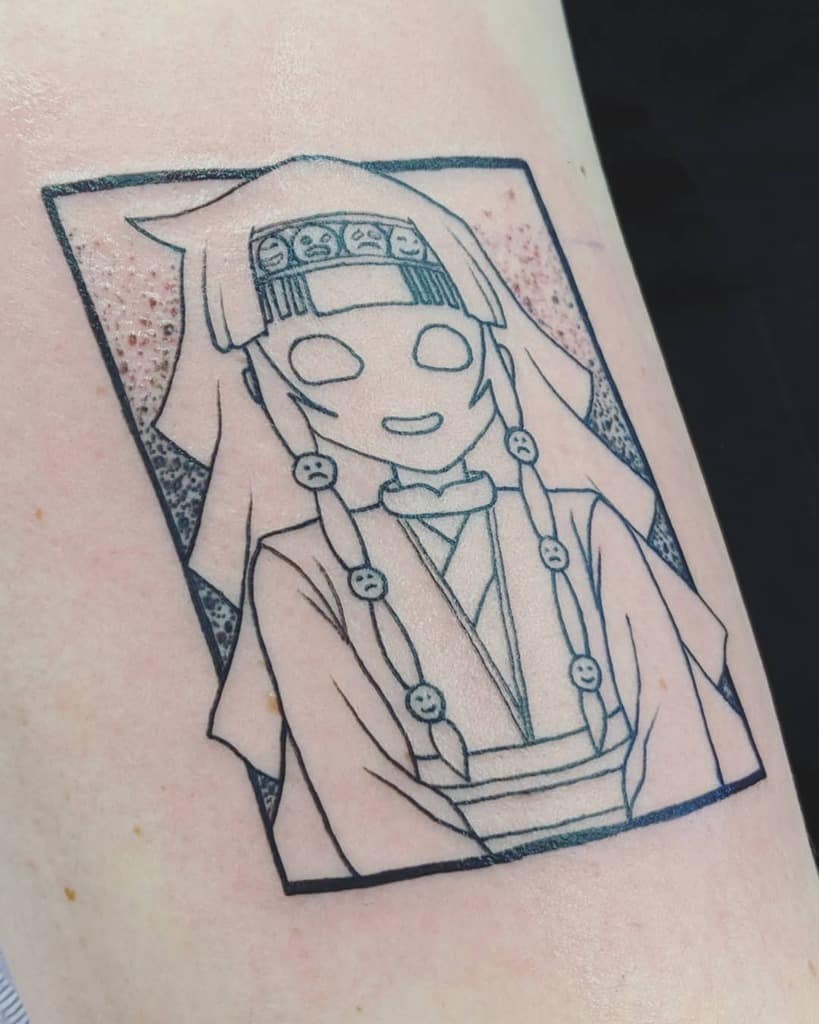 Black-ink tattoo of Alluka Zoldyck from Hunter x Hunter, featuring her intricate outfit and braided hair with smiling face details