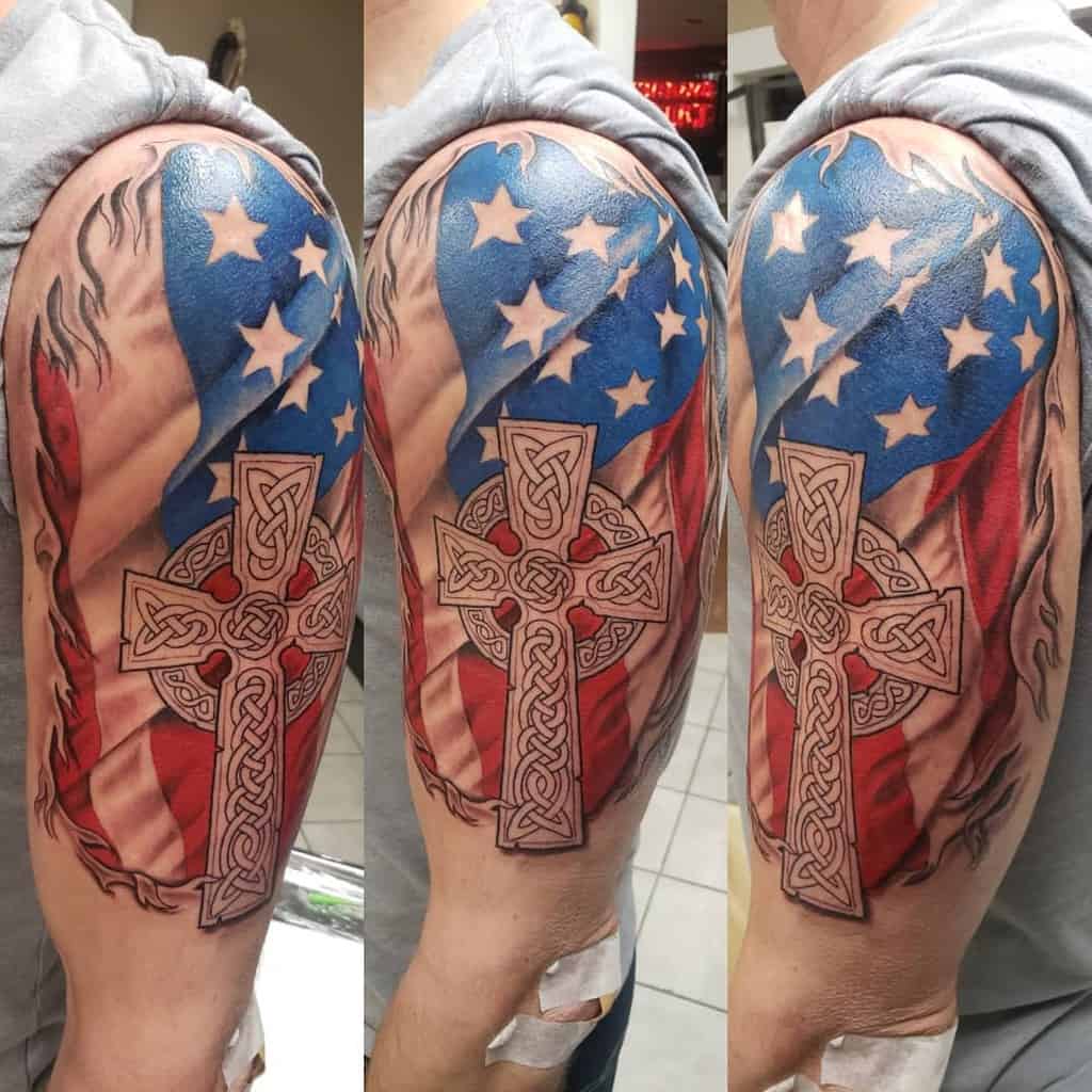 Arm tattoo of a Celtic cross overlaid on an American flag design