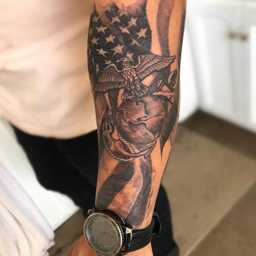 Forearm tattoo with an eagle, globe, anchor, and American flag design