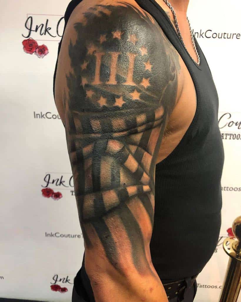 Arm tattoo with stars and stripes in a black ink design