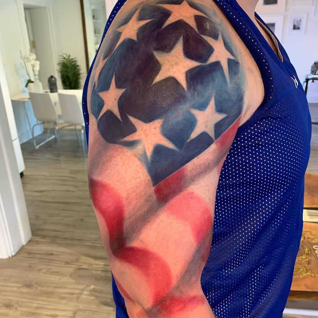 Arm tattoo of the U.S. flag with stars and stripes