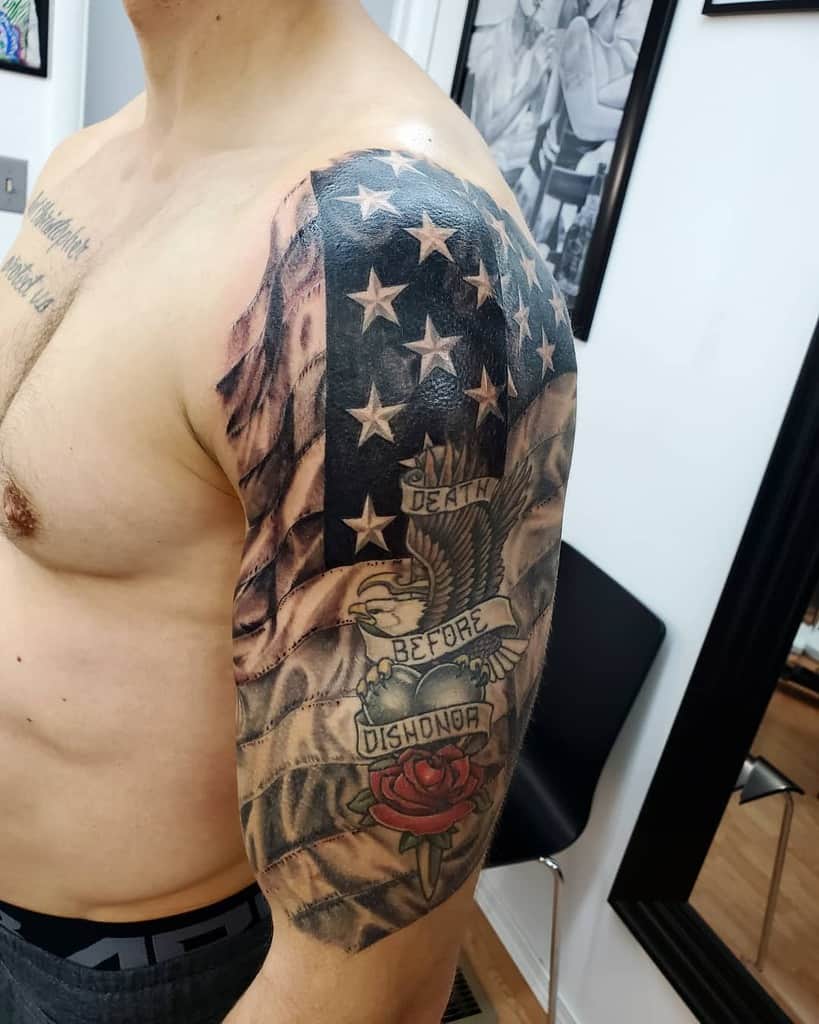 Man with American flag and "Death Before Dishonor" tattoo on upper arm