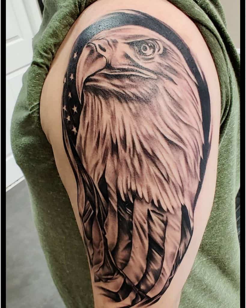Eagle tattoo on upper arm with American flag elements in the background