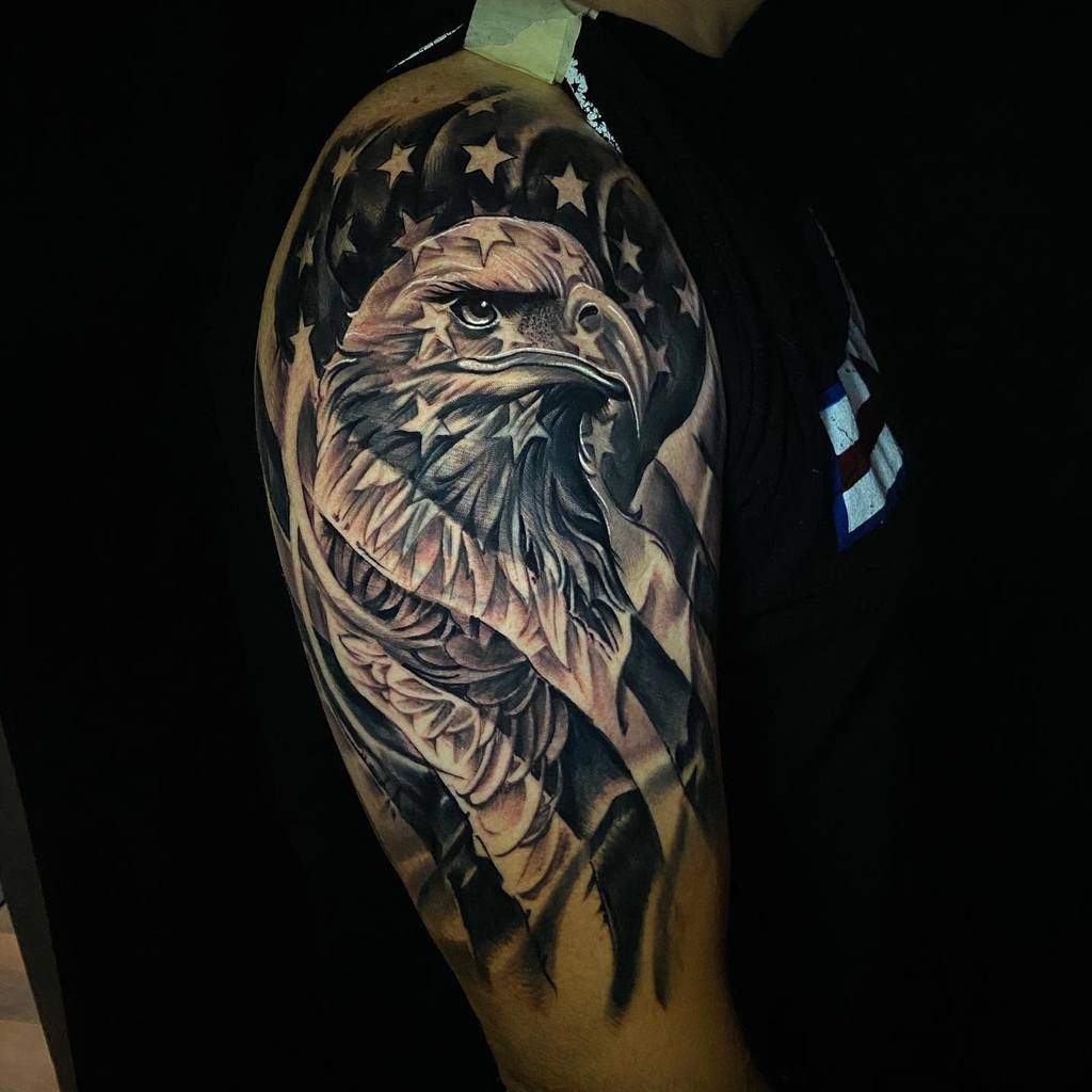 Tattoo of an eagle with American flag background on an upper arm