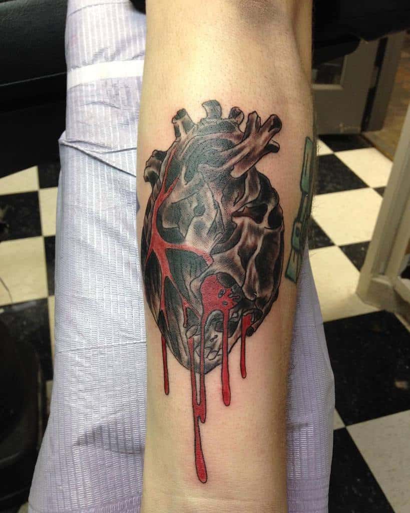 Realistic heart tattoo with red veins and bleeding ink, dripping elegantly down the arm