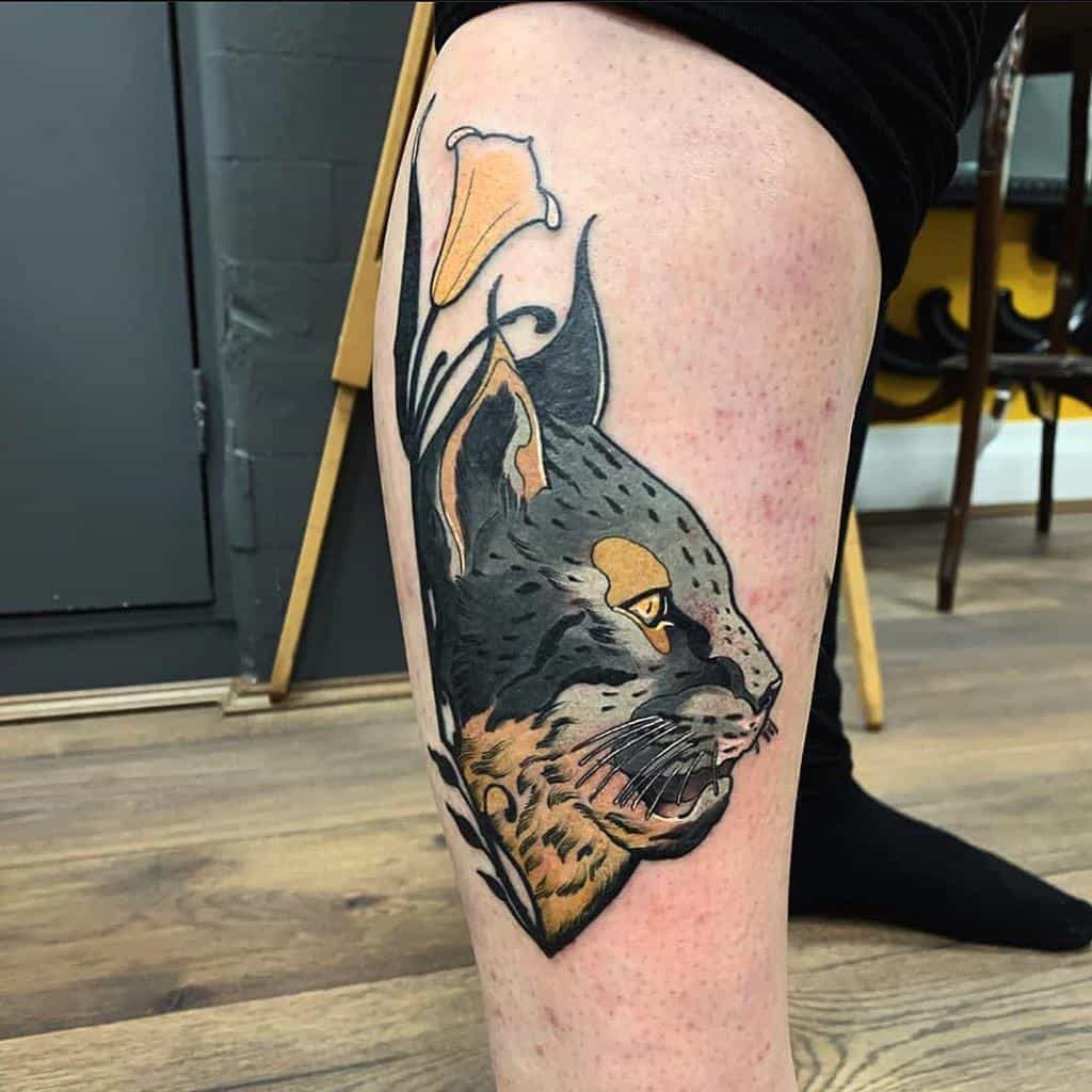 Art Nouveau-style tattoo of a lynx with flowing lines and organic shapes, featuring delicate floral accents