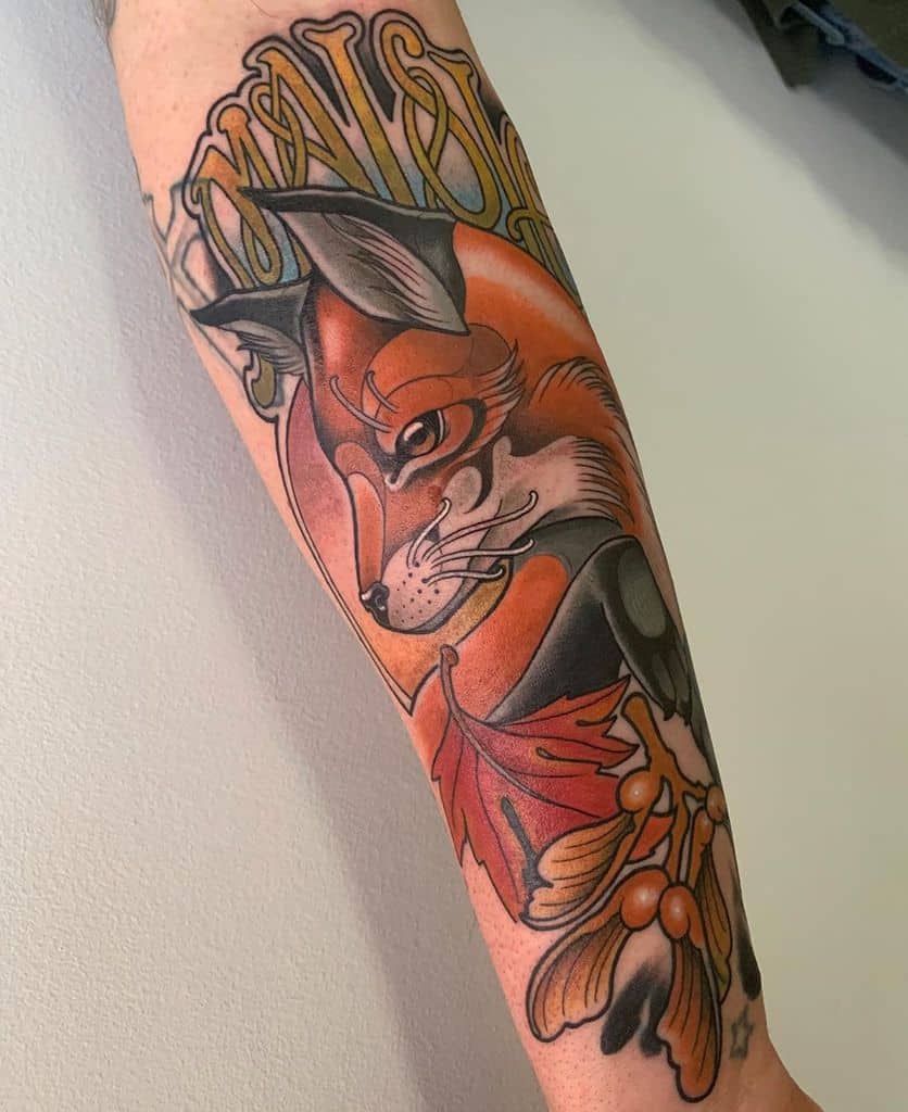 Art Nouveau-style tattoo of a fox with an intense gaze, framed by autumn leaves, berries, and elegant flowing typography