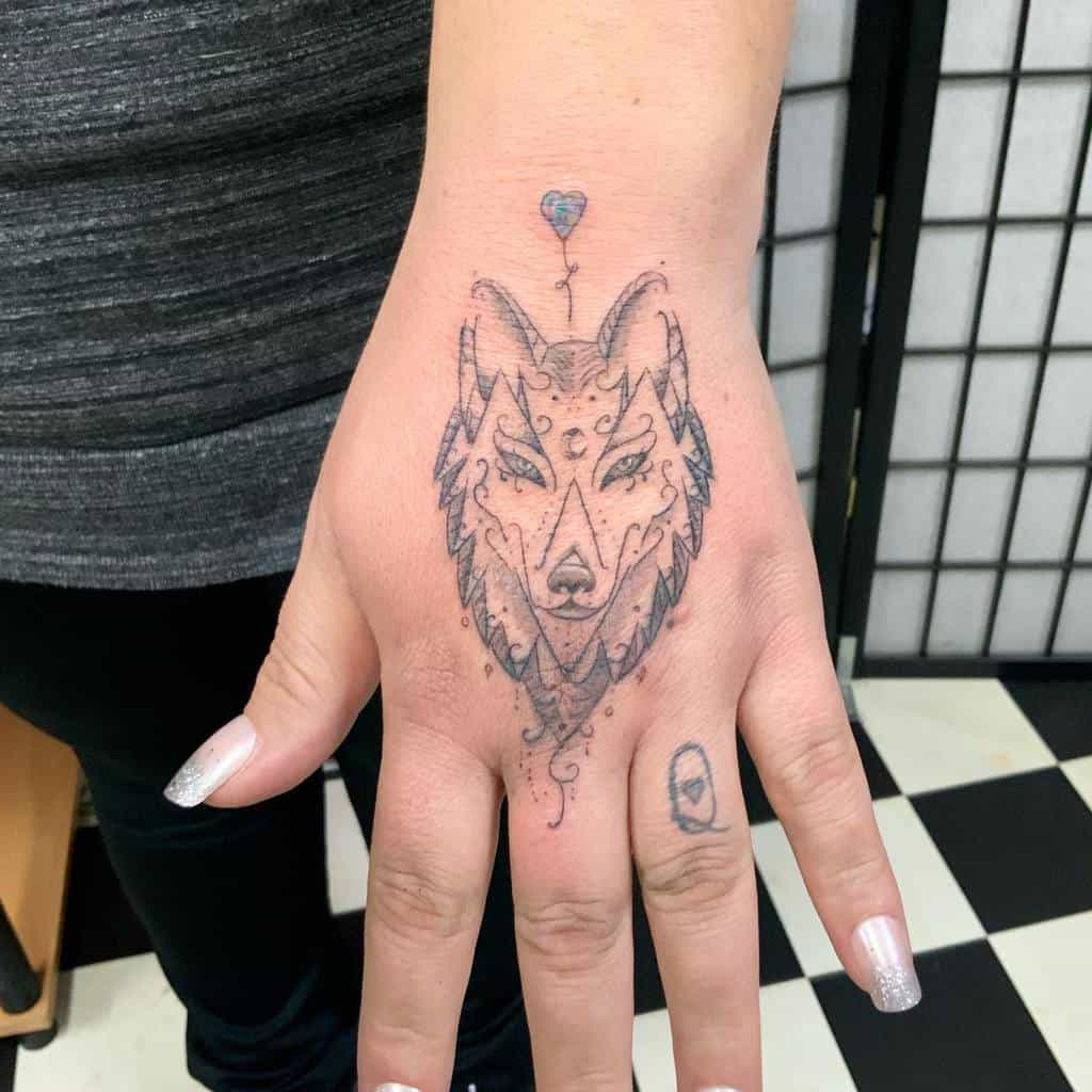 Elegant wolf tattoo featuring fine line details, geometric elements, and a small heart balloon above