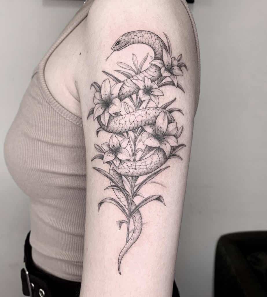 Elegant black and grey tattoo of a snake entwined with blooming lilies, symbolizing transformation, mystery, and natural beauty