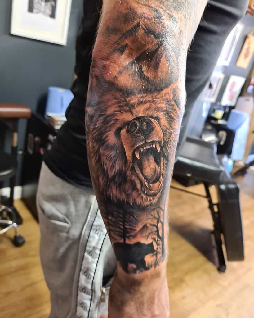 Realistic bear tattoo on a man's forearm