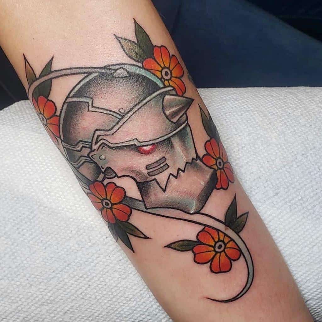 Colorful Fullmetal Alchemist tattoo of Alphonse Elric’s armored head, surrounded by vibrant orange flowers and winding vines