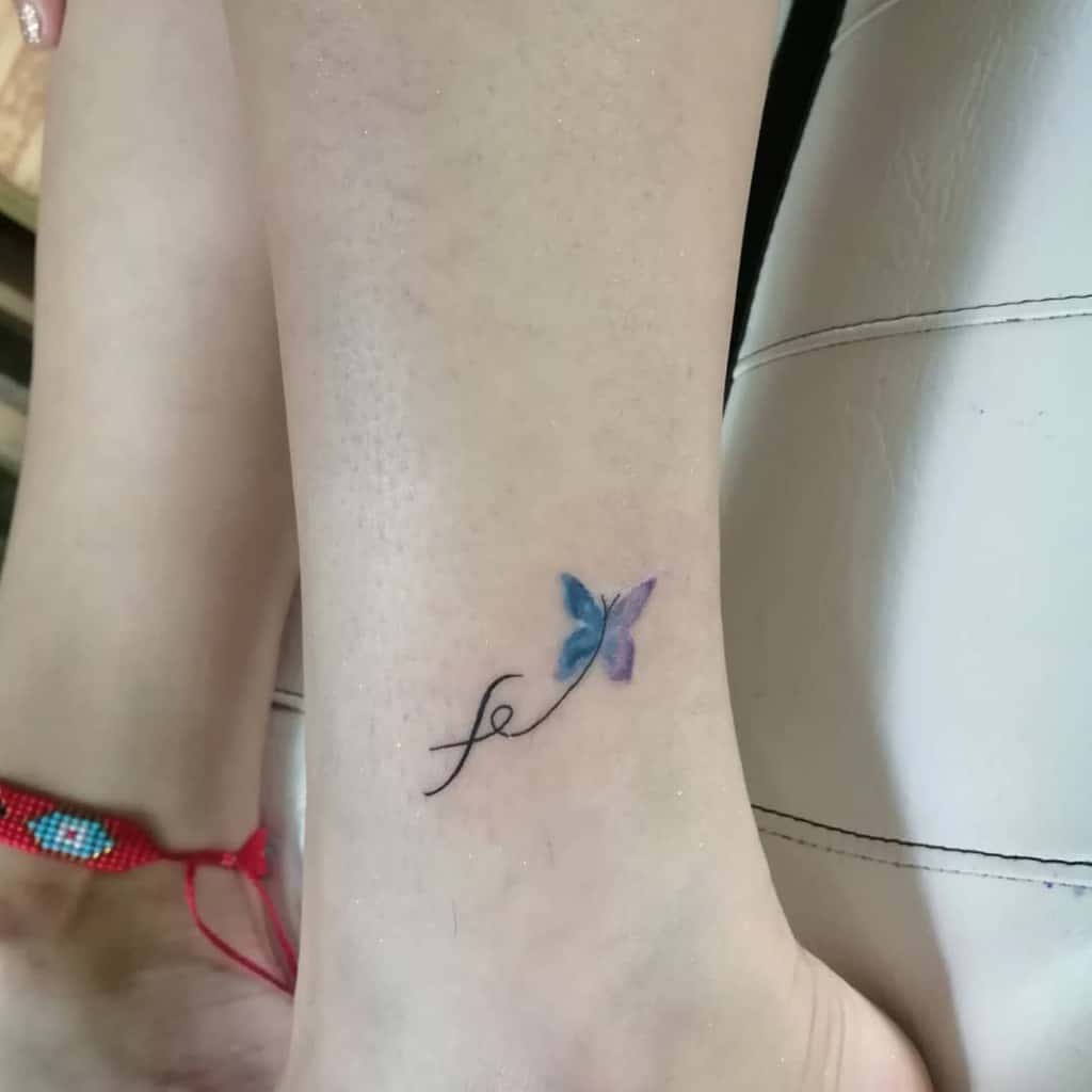 A delicate blue and purple butterfly tattoo graces the ankle