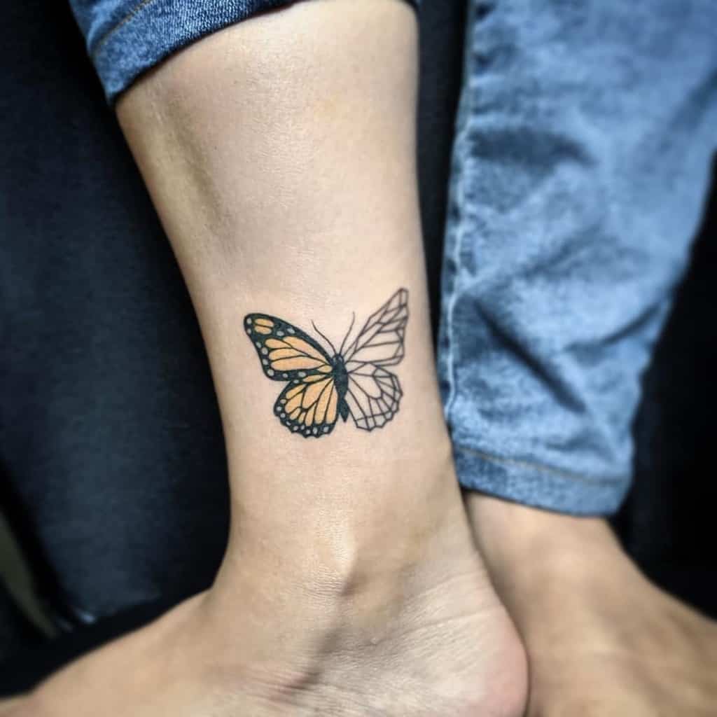 A vibrant monarch butterfly tattoo, both in color and outline, graces an ankle