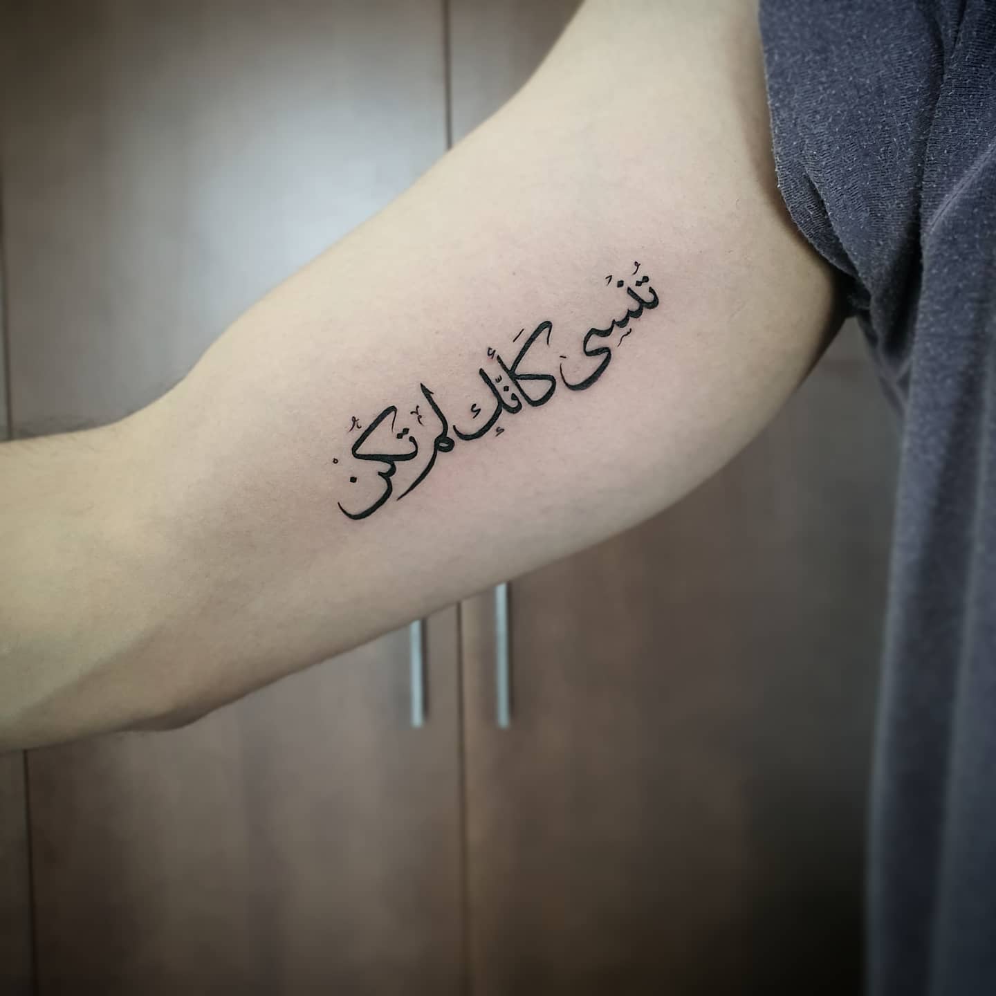 Tattoo of Arabic script on an arm