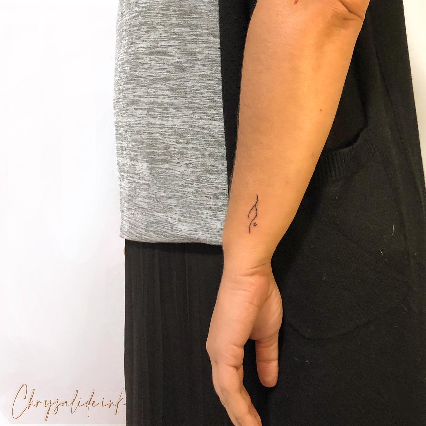 Minimalistic tattoo on forearm