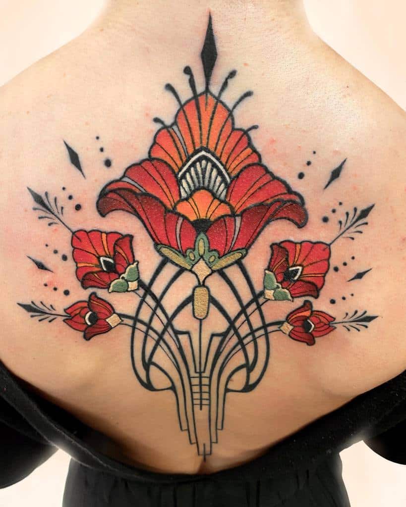 Art Nouveau tattoo featuring bold red flowers, geometric linework, and intricate black and gold detailing in a symmetrical design
