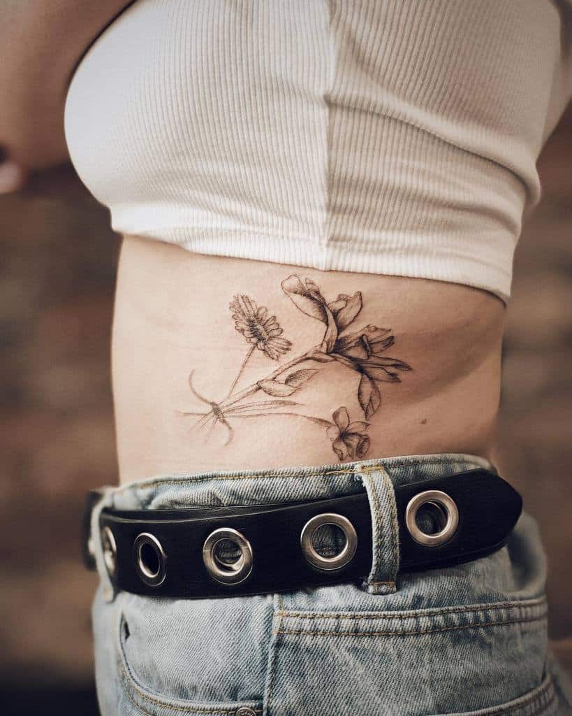 Side black and white tattoo of aster flowers