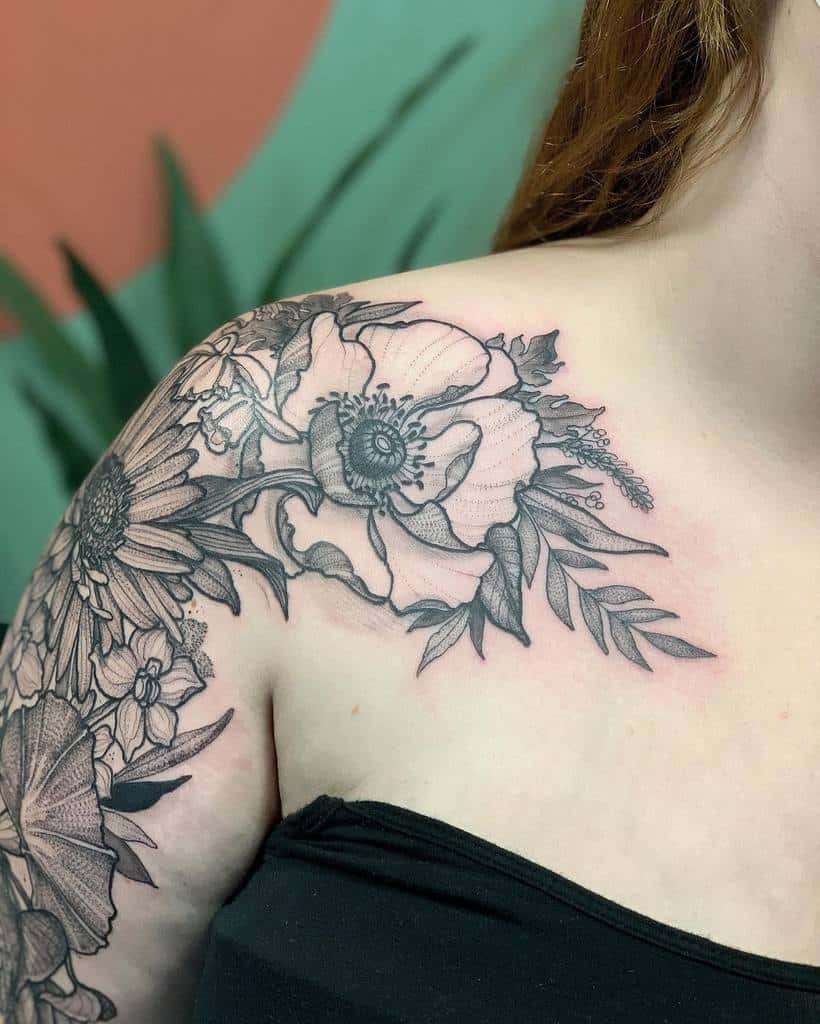 Intricate shoulder tattoo with an aster and large flowers, creating a soft, elegant design