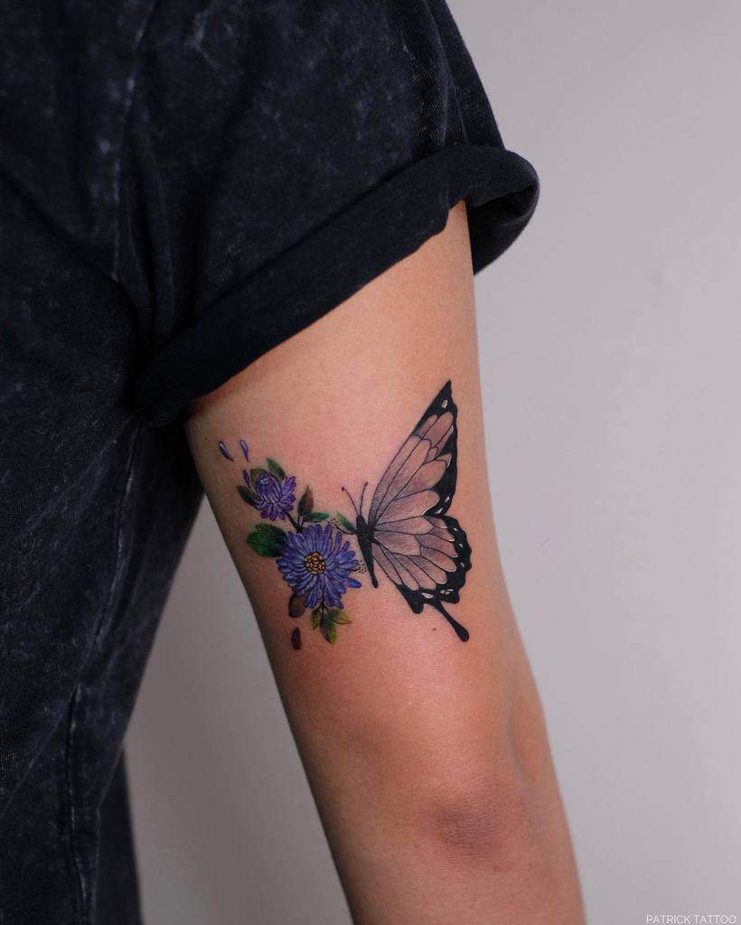 Arm tattoo of a butterfly with purple aster flowers