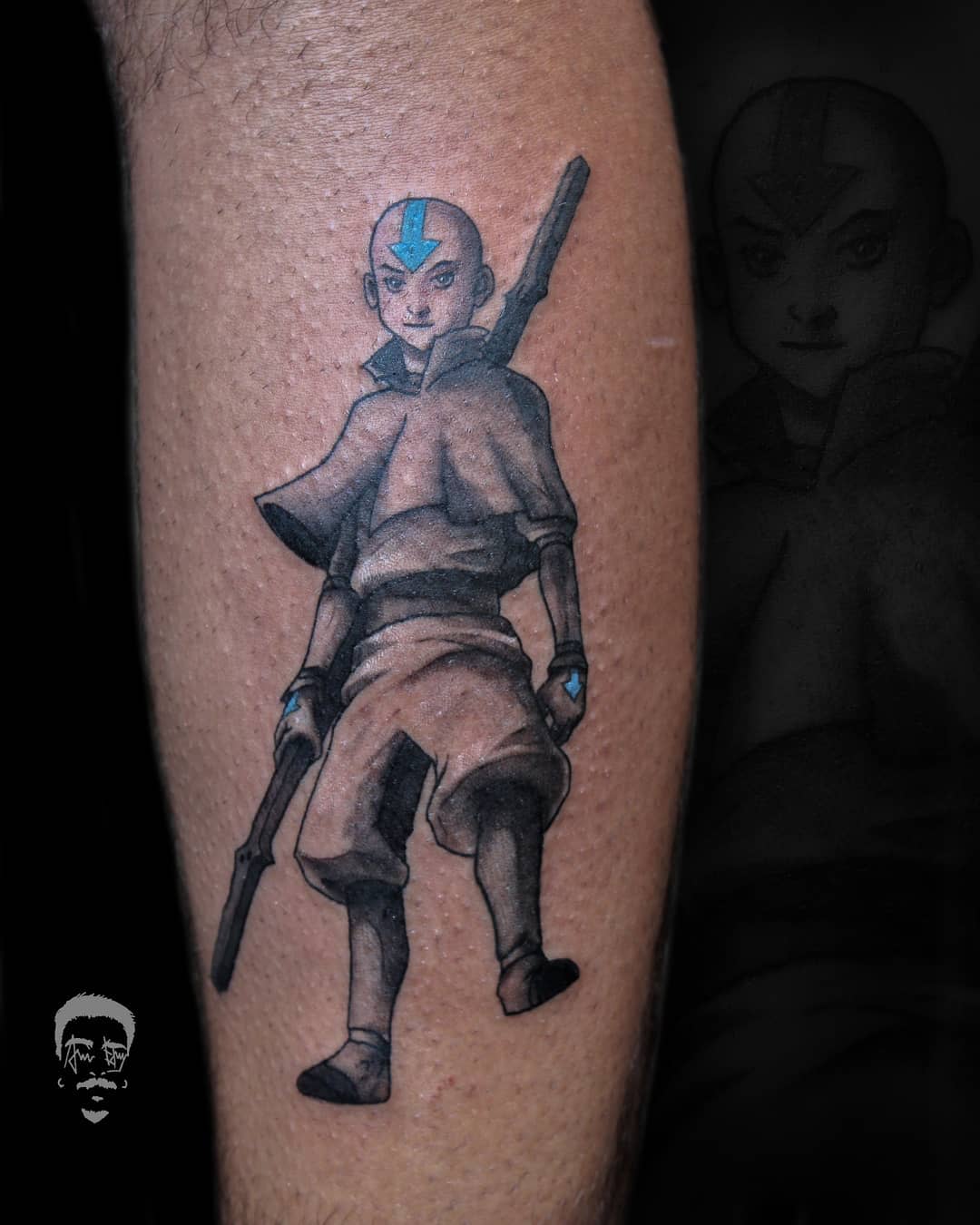 Tattoo of Aang standing confidently with his staff