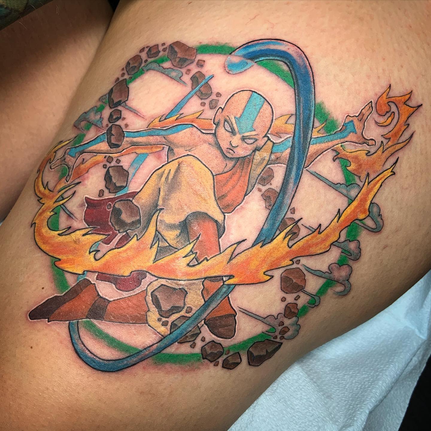 Tattoo of Aang from Avatar: The Last Airbender in a dynamic pose, bending all four elements