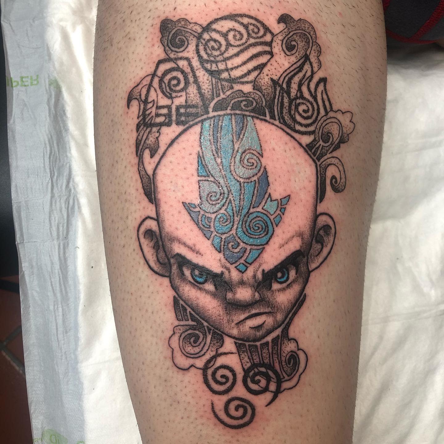 Tattoo of Aang from Avatar: The Last Airbender in the Avatar State, with swirling elements around his head