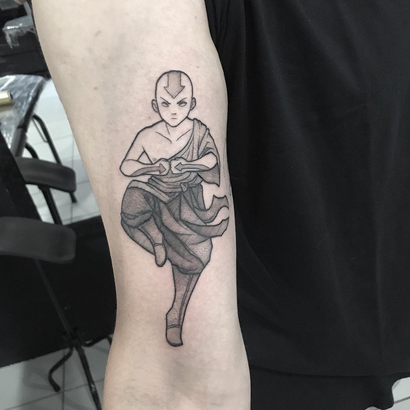 Tattoo of Aang in a meditative stance, balancing on one foot