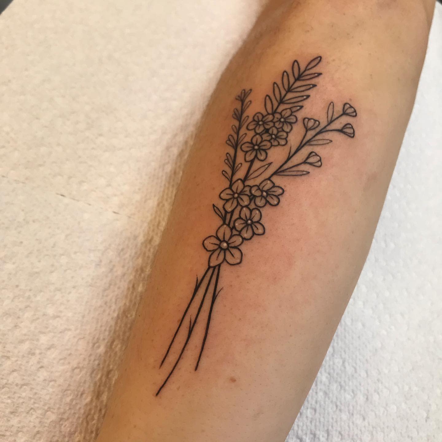 Outline floral tattoo featuring baby's-breath on a forearm
