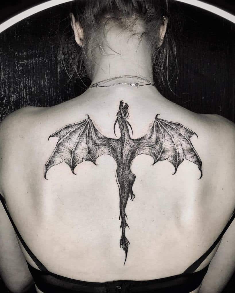 Woman with a large dragon tattoo on her upper back