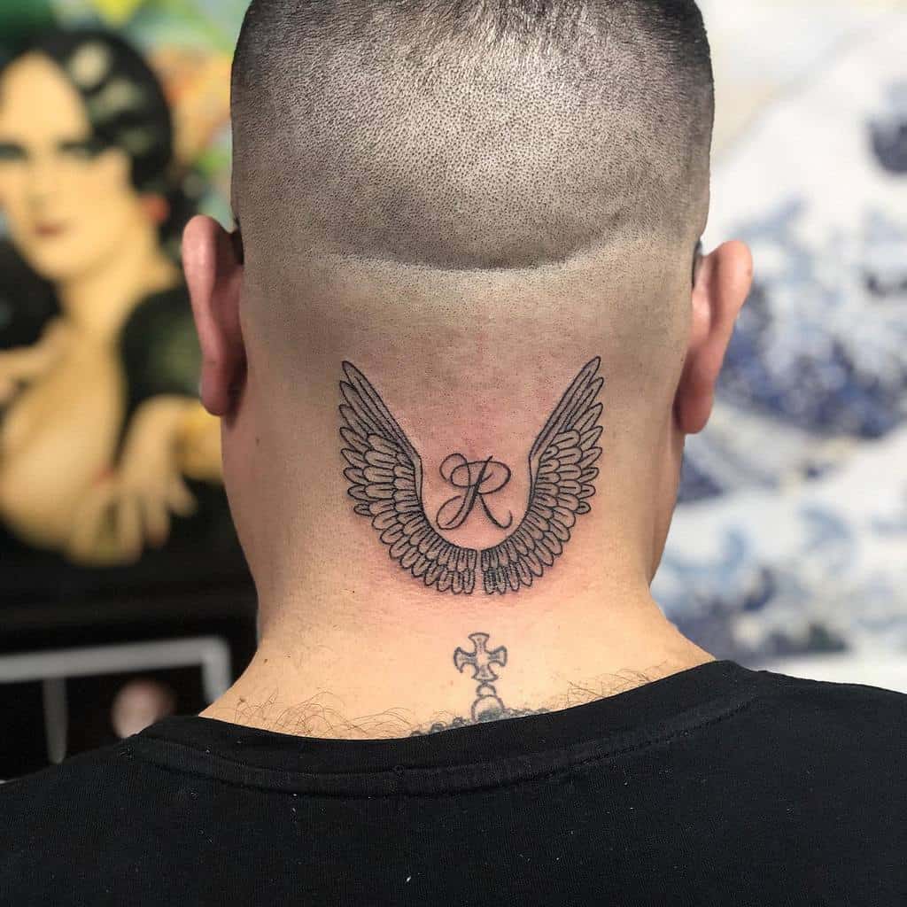 Tattoo of wings and the letter "R" on the back of a person's neck