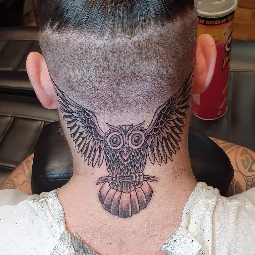 Owl tattoo on the back of a person's neck with a Pringles can in the background
