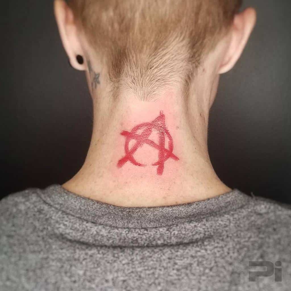 A red anarchy symbol tattoo on the back of the neck