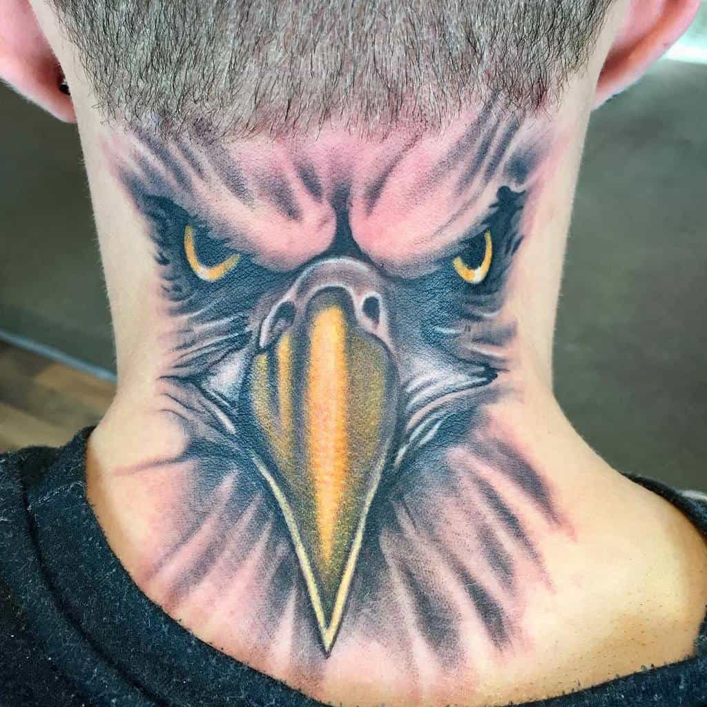 Tattoo of an eagle's intense stare dominating the back of neck