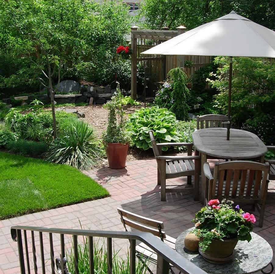 large backyard garden wood patio furniture plants paved patio
