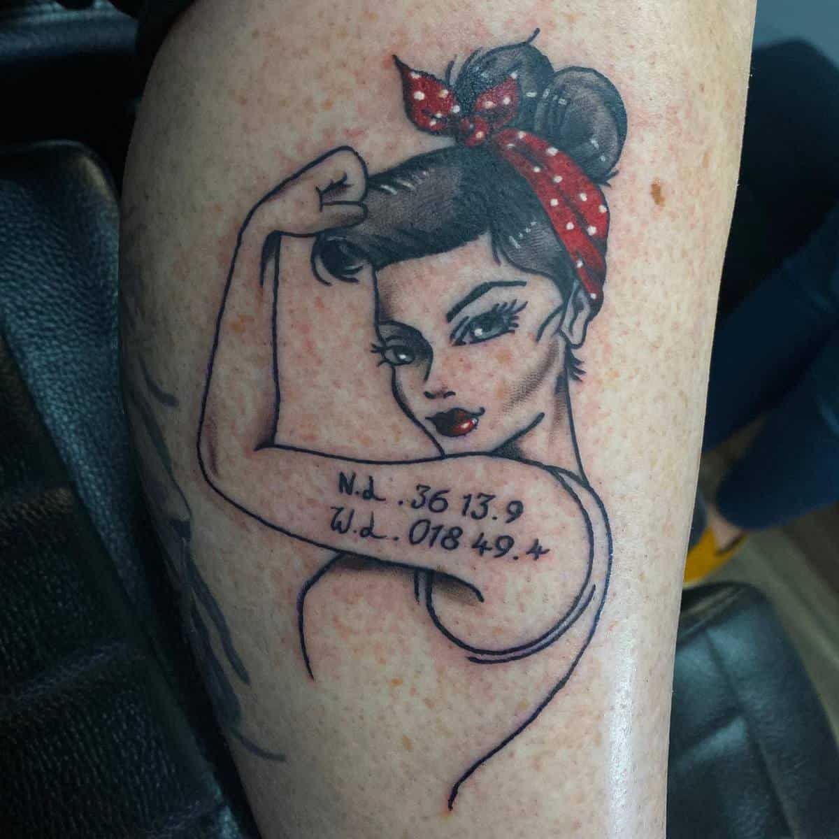 Tattoo of a Rosie the Riveter flexing her bicep with a red polka dot headscarf and coordinates written on her arm