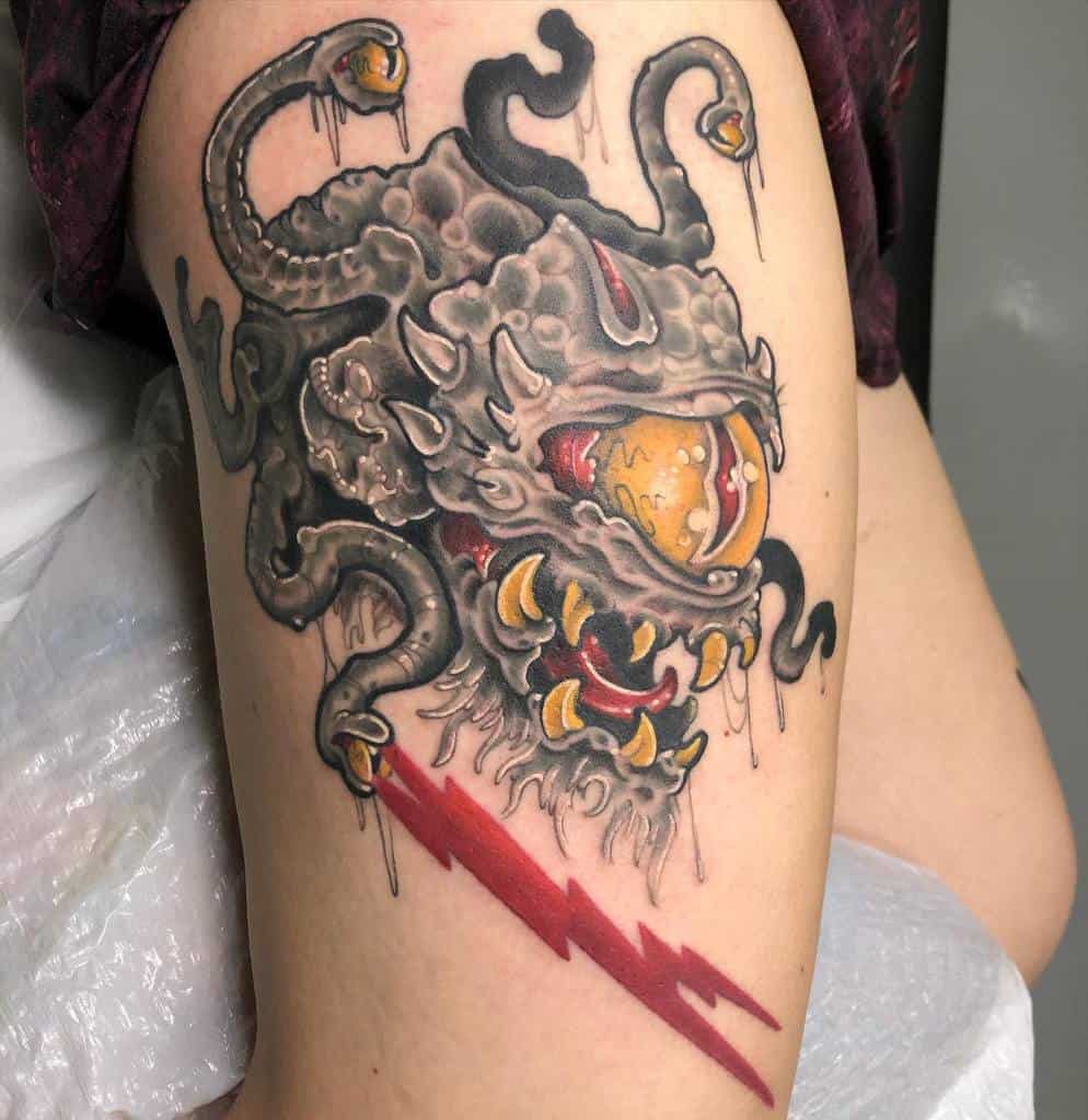 Dynamic Dungeons & Dragons tattoo of a Beholder with glowing yellow eyes, sharp teeth, and a bold red lightning bolt accent
