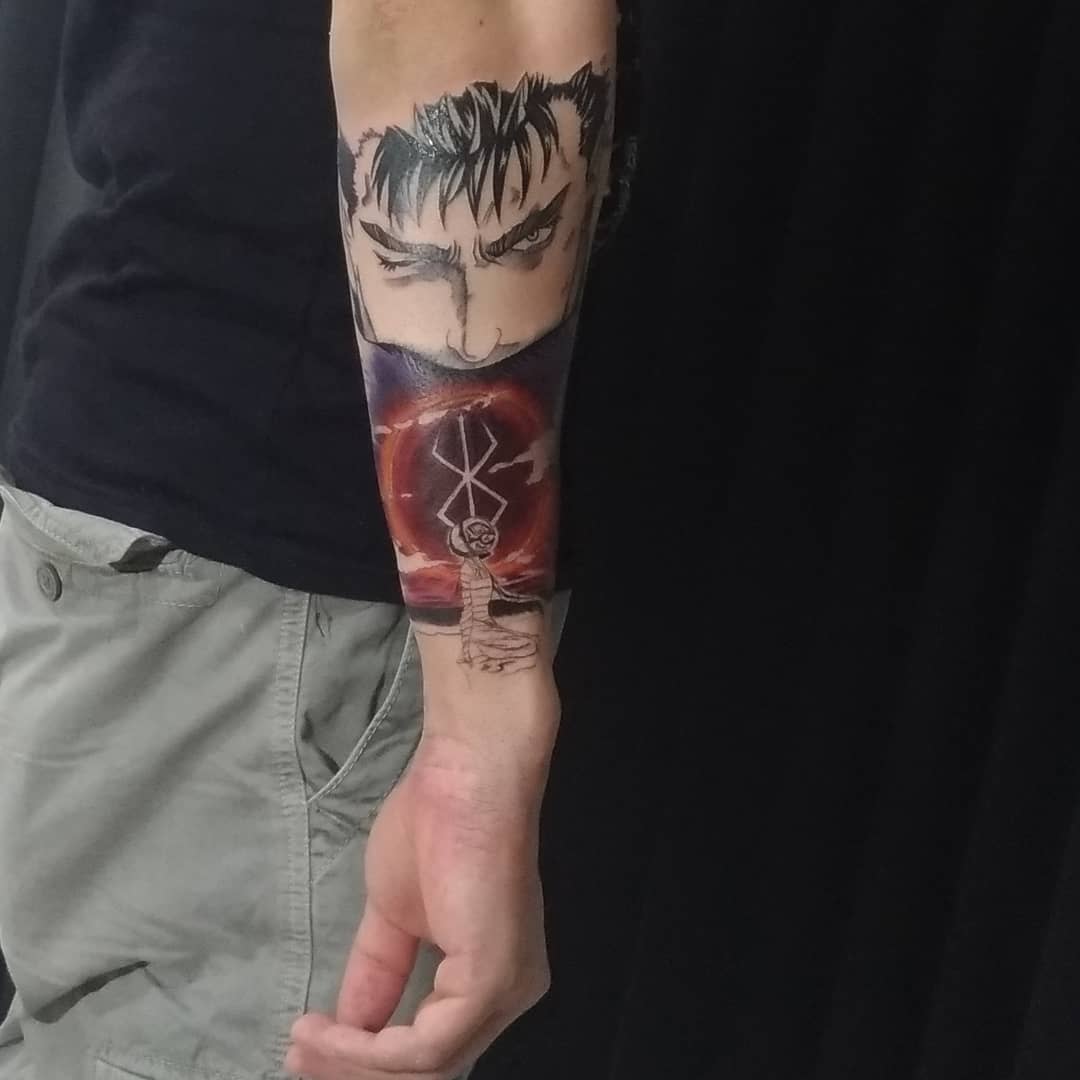 Forearm tattoo featuring an intense face over a glowing orb with symbols atop a lighthouse