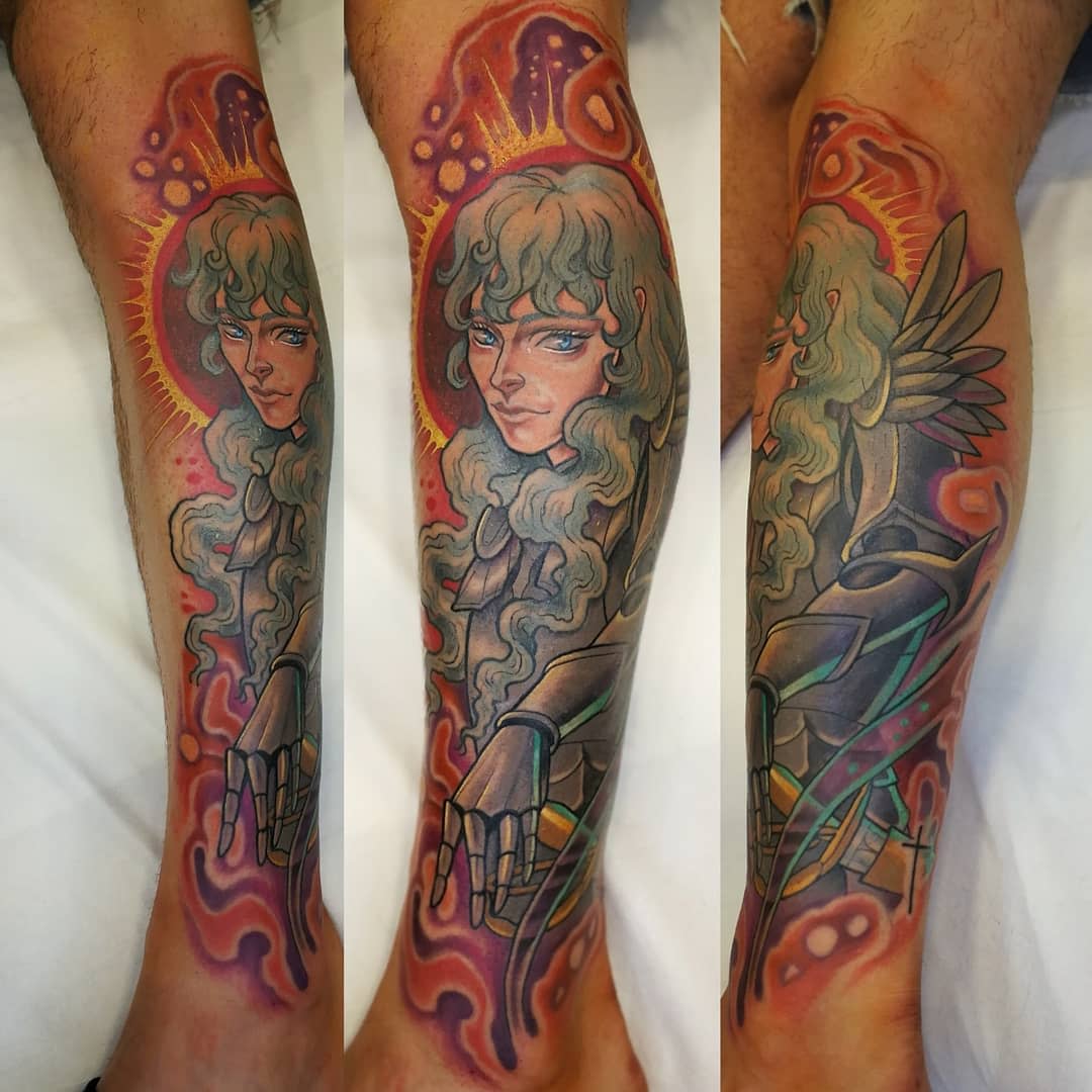 Vibrant color tattoo of Griffith from Berserk on the leg, featuring detailed shading and a glowing halo effect around his head, with ethereal and surreal background elements