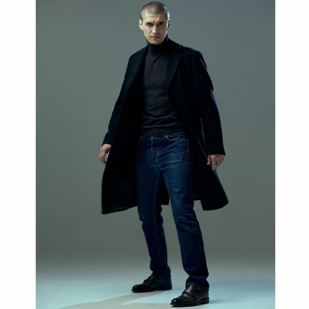 Angry,Looking,Man,In,Black,Coat,On,Gray,Studio,Background.