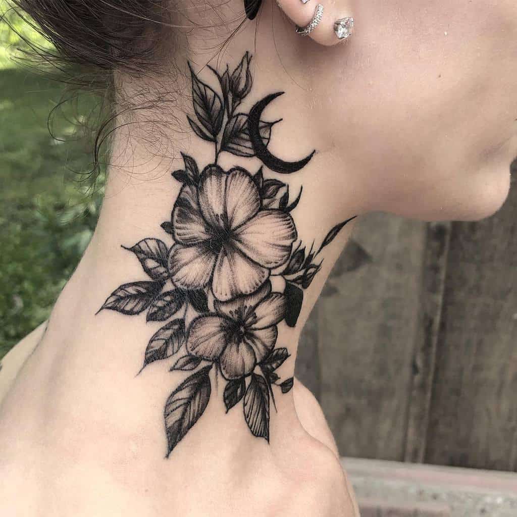 A neck tattoo featuring delicate dogwood flowers, intertwining leaves, and a crescent moon in black ink