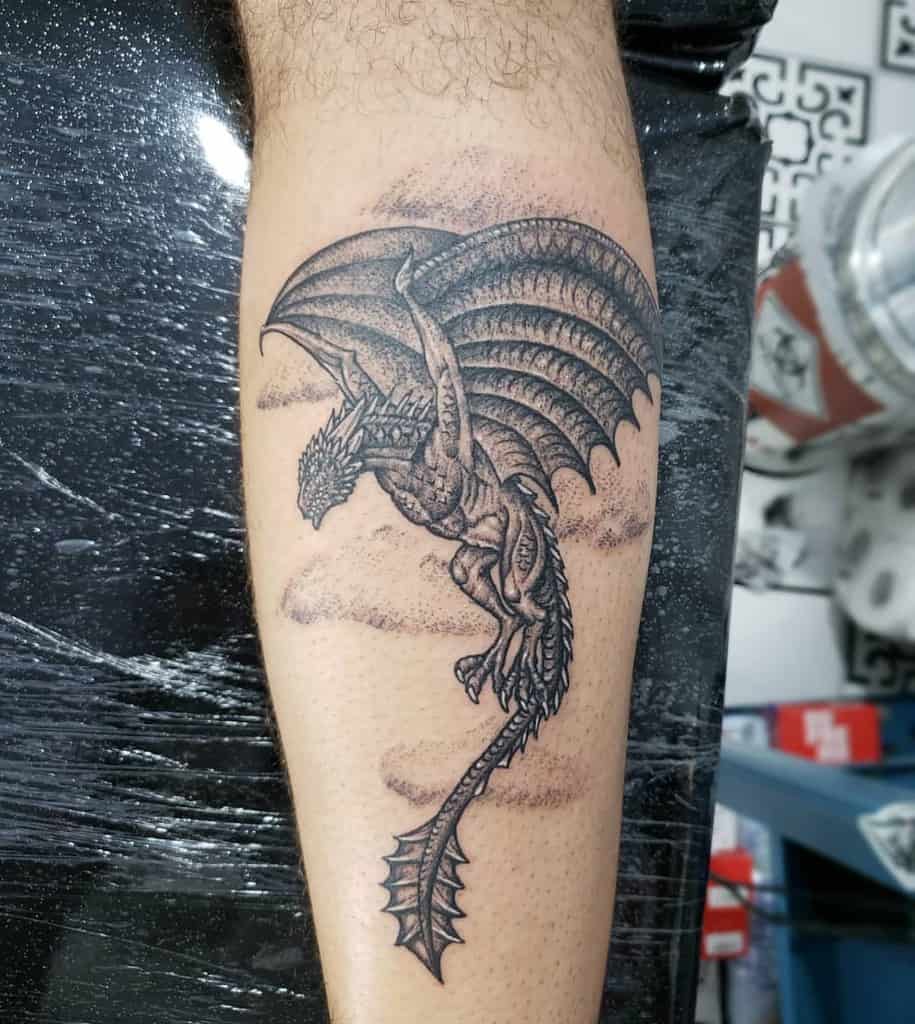 Forearm tattoo of a detailed dragon in flight with outstretched wings and textured scales