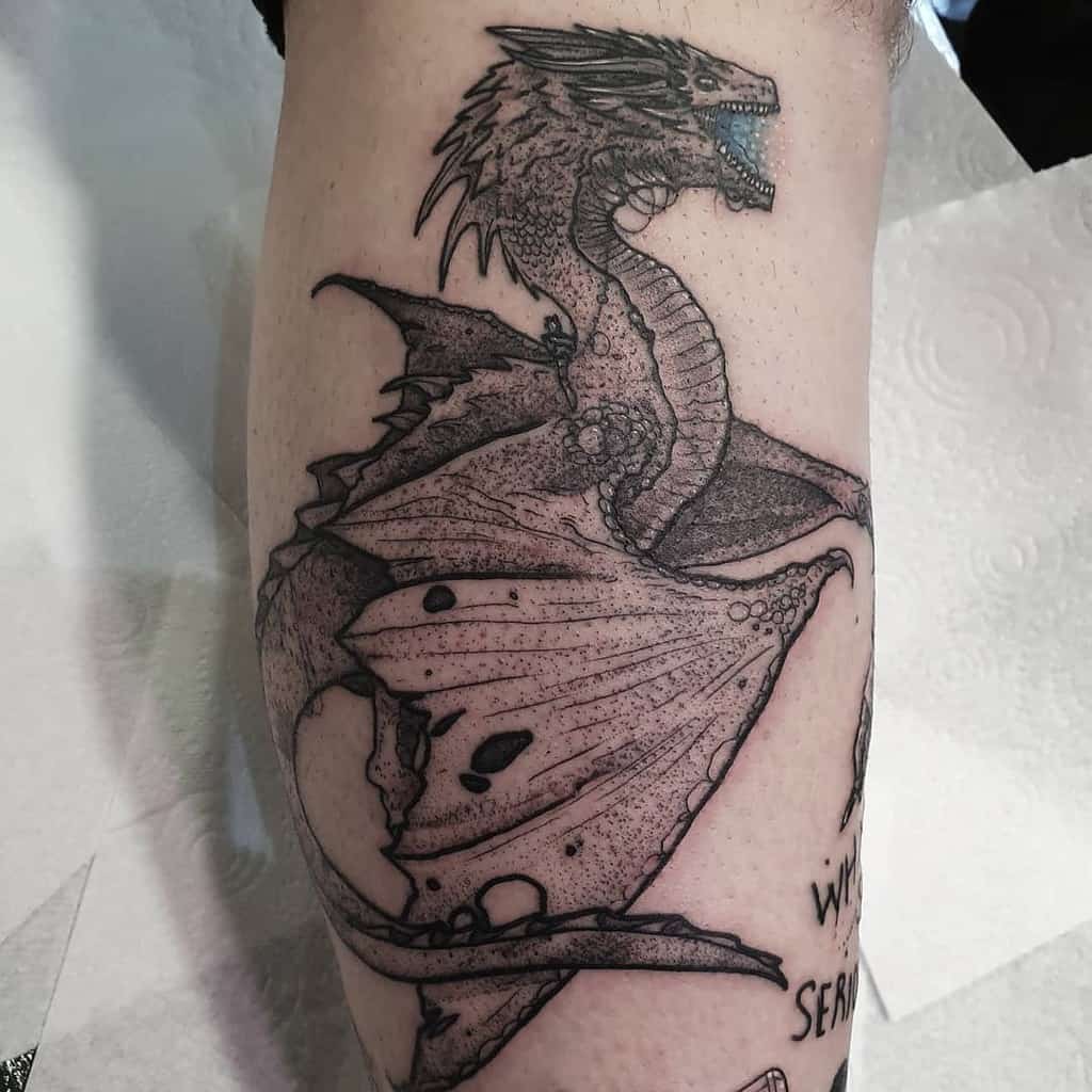 Detailed black ink tattoo of a roaring dragon with textured scales and wings on the forearm