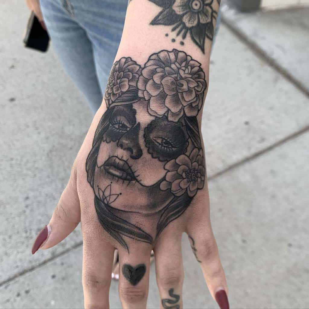 Tattoo of a woman’s face with floral crown and sugar skull makeup