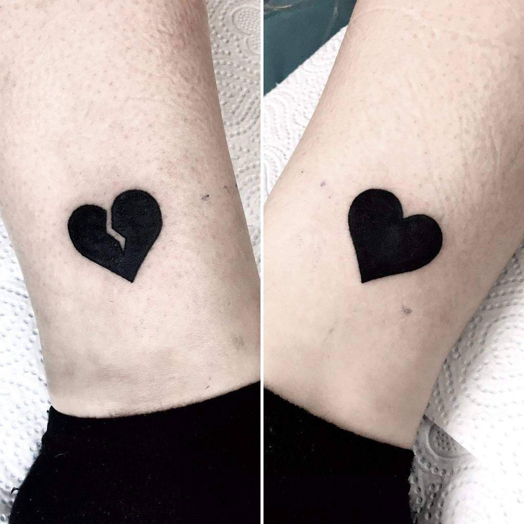 Two images of a simple black heart tattoo; the left shows a heart with a vertical crack, and the right shows an intact heart