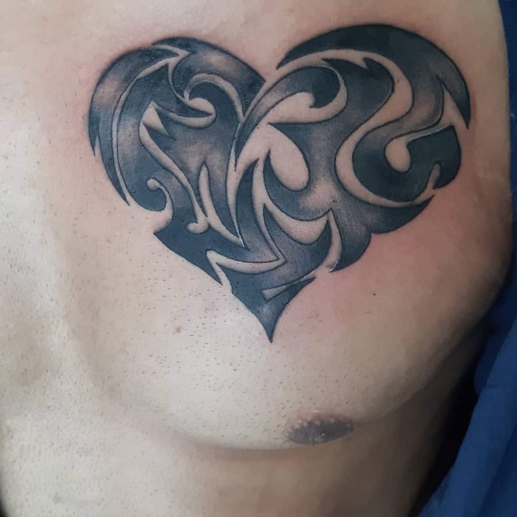 Tribal-style black heart tattoo, featuring intricate swirls and sharp edges, creating a bold, dynamic design